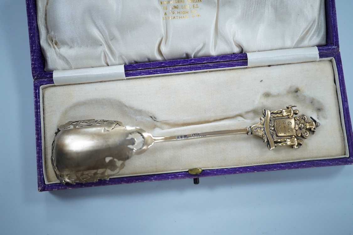 A cased silver gilt and polychrome enamelled spoon, the terminal modelled as the crest of the Worshipful Company of Joiners and Ceilers, to commemorate the Coronation of George V in 1911, Levi & Salaman, London, 1910, 17